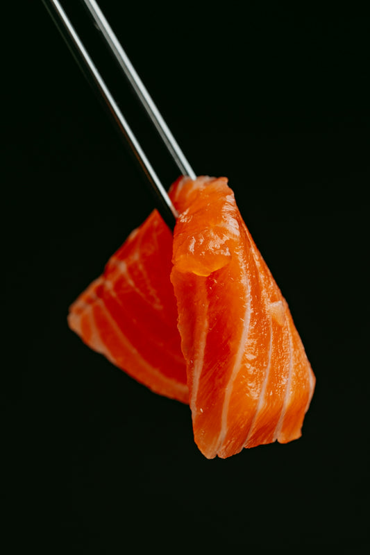 a piece of sushi with chopsticks sticking out of it