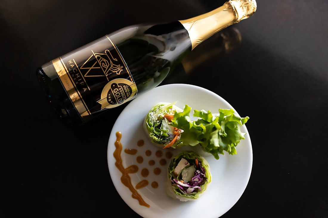 a plate of food and a bottle of wine on a table