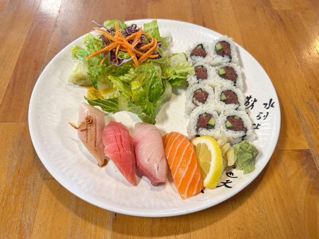 a white plate topped with sushi and vegetables